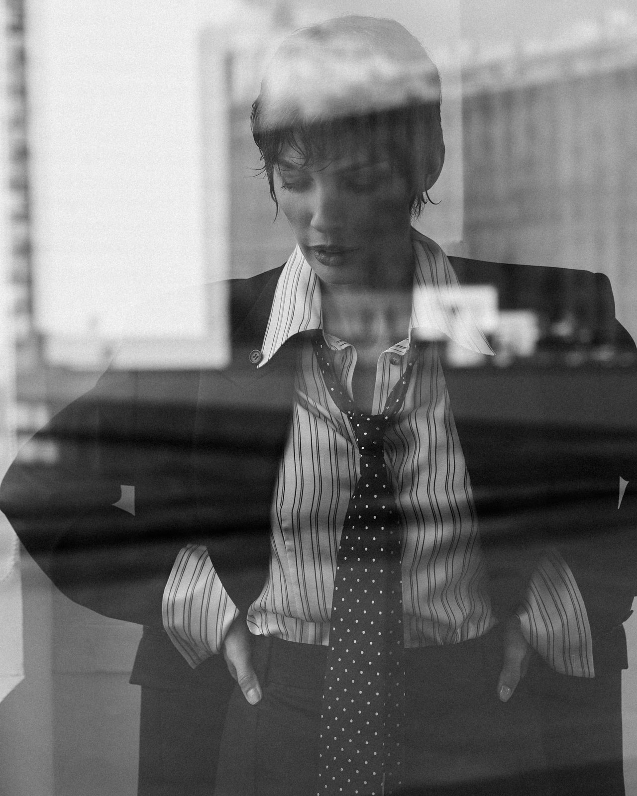 Natalia Boykova behind glass, suit and tie