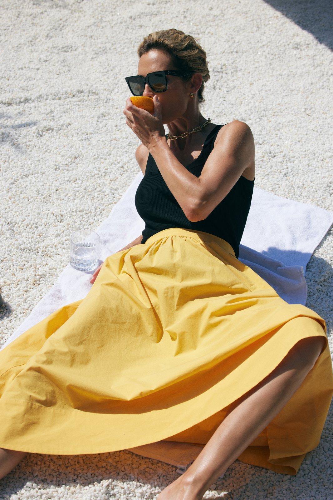 Natalia Boykova in a yellow skirt, outdoors in sunlight
